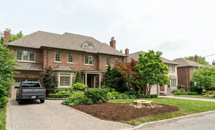 A wide view of a well-maintained residential property showing improved open space and daylight after a professional service successfully extracted a massive, hazardous tree from the front yard.